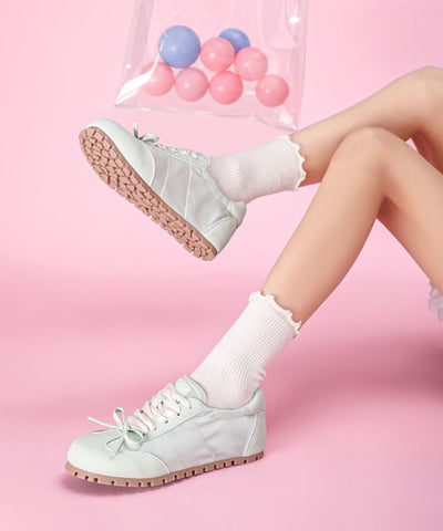 Lässige flache Schuhe mit Schleife und Kreuzriemen aus rosa Kunstleder  Lässige flache Schuhe mit Schleife und Kreuzriemen aus rosa Kunstleder