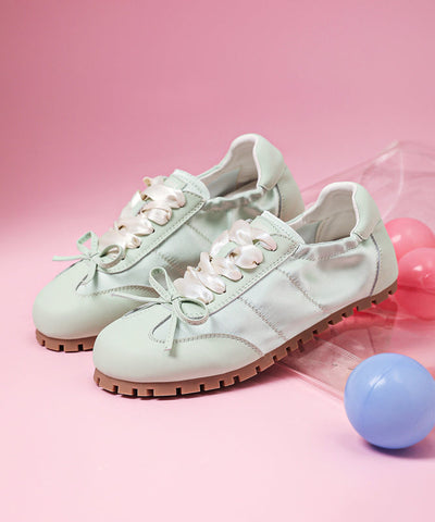 Lässige flache Schuhe mit Schleife und Kreuzriemen aus rosa Kunstleder  Lässige flache Schuhe mit Schleife und Kreuzriemen aus rosa Kunstleder