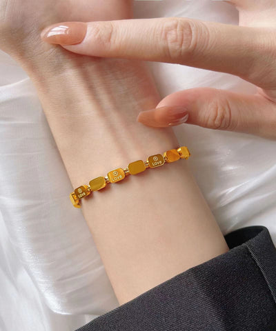 Hermosa pulsera de acero inoxidable dorado con cadena de hueso de serpiente y forma de corazón. 
