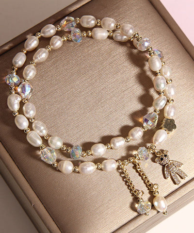 Pulsera informal con dije de osito de perla con incrustaciones de aleación de champán 