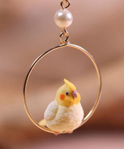 Lindos pendientes colgantes de loro en plata de ley dorada 