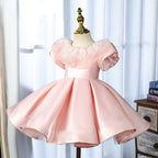 Elegantes rosa Prinzessinnenkleid mit Puffärmeln für Babys und Kleinkinder – auch ideal zur Erstkommunion 