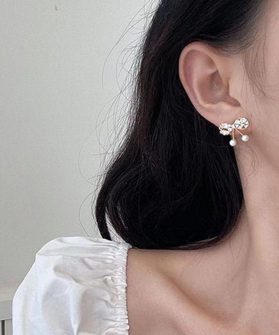 Moderne Ohrstecker mit Schleife aus Goldlegierung mit Zirkonia und Perlen 