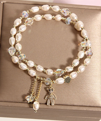 Pulsera informal con dije de osito de perla con incrustaciones de aleación de champán 
