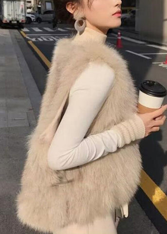 Elegante chaleco de piel y piel color albaricoque, sin mangas, con cuello redondo y cremallera 