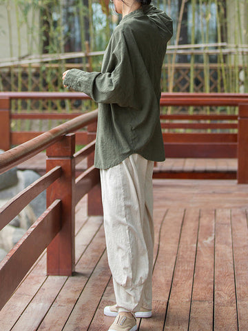 Blusas plisadas de color liso con cuello alto, mangas murciélago y botones de rana chinos sueltos. 