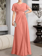 A-Linien-Kleid aus Chiffon mit Rundhalsausschnitt und bodenlanger Verarbeitung, verziert mit plissierten Perlen.