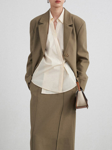 Conjunto de tres piezas de blusa y camisa de manga larga con solapa, botones sueltos, falda, pantalón y blazer con cuello con muescas. 