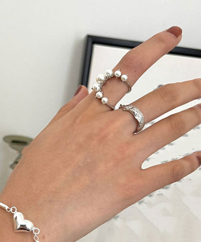 Conjunto de dos anillos de plata de ley con perlas y seda fina 
