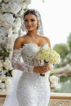 Hermoso vestido de novia largo blanco de sirena con hombros descubiertos, encaje brillante y mangas largas