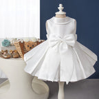 Elegantes weißes, ärmelloses, rückenfreies Faltenkleid mit Schleife für Babys – auch als Kommunionskleid für Kleinkinder geeignet. 