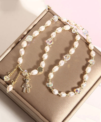 Pulsera informal con dije de osito de perla con incrustaciones de aleación de champán 