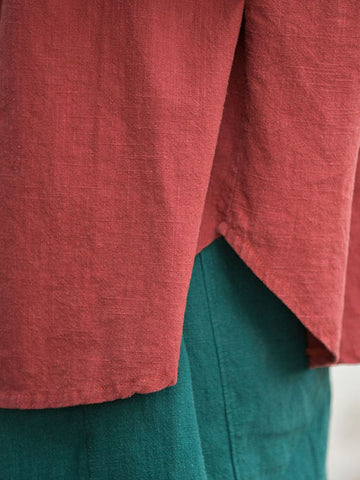 Blusas plisadas de color liso con cuello alto, mangas murciélago y botones de rana chinos sueltos. 