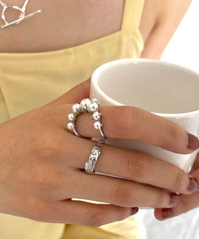 Conjunto de dos anillos de plata de ley con perlas y seda fina 