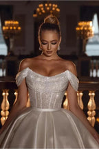 Lujoso vestido de novia largo de satén con lentejuelas brillantes y hombros descubiertos